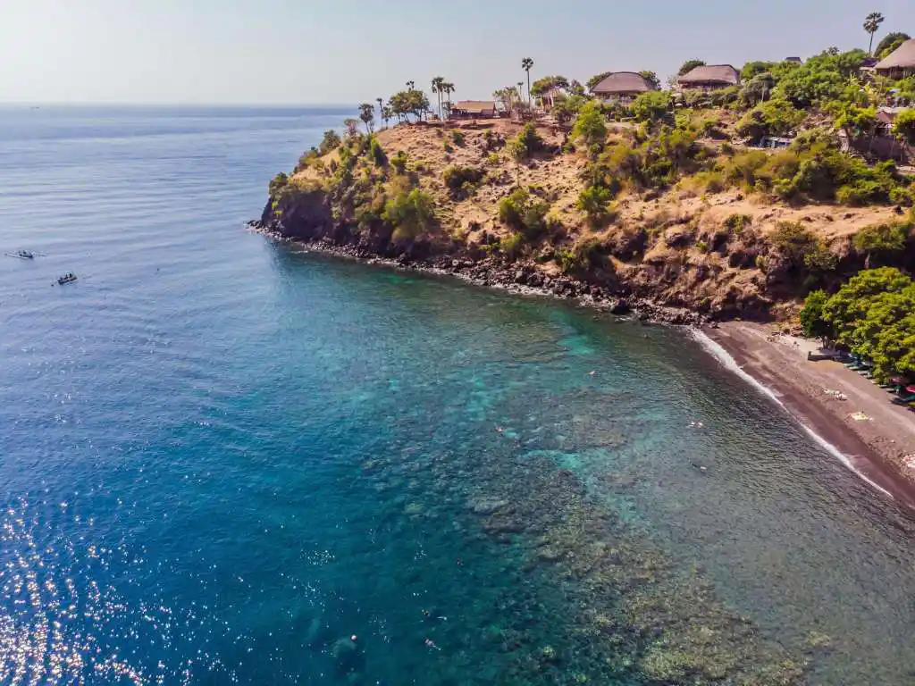 Jemeluk Bay underwater temple snorkeling Amed Bali — colorful coral reef and tropical fish