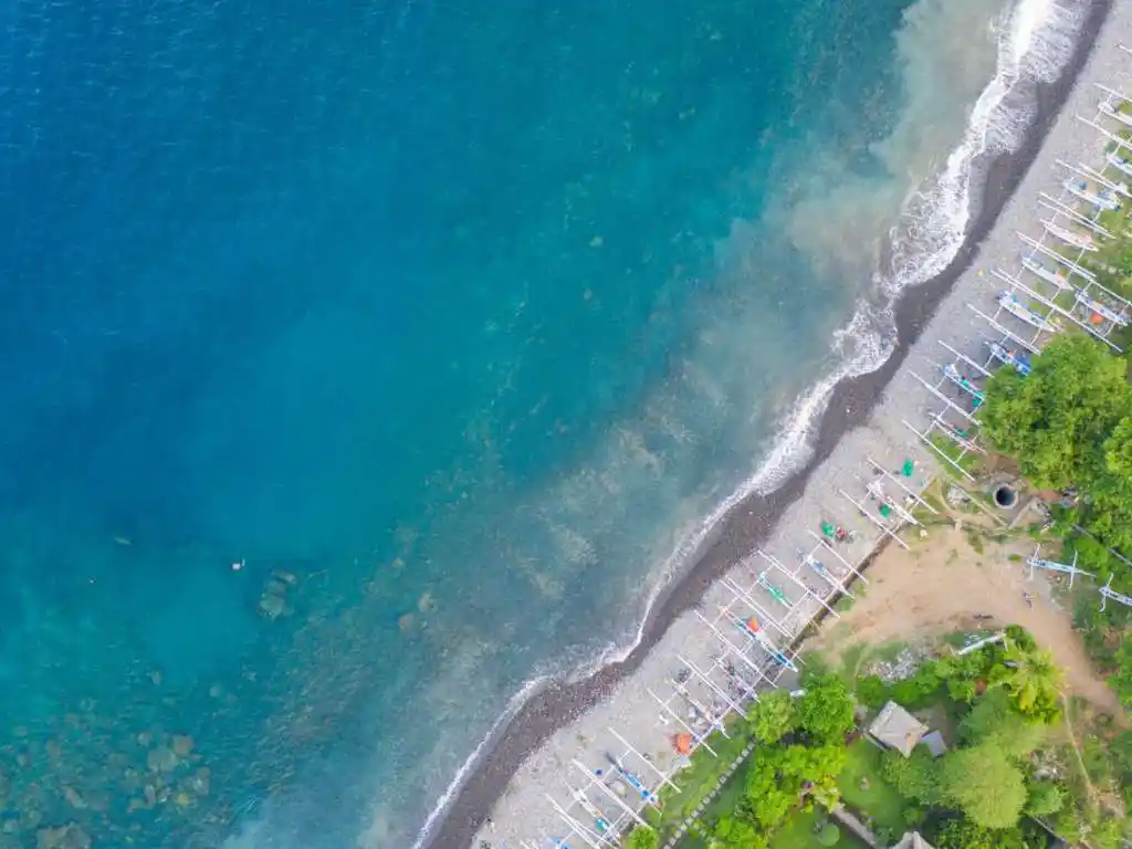 Amed Bay black sand beach with Mount Agung in the background, Bali