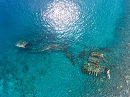 Japanese WWII shipwreck snorkeling spot in Banyuning, Amed Bali — coral-covered wreck with tropical fish